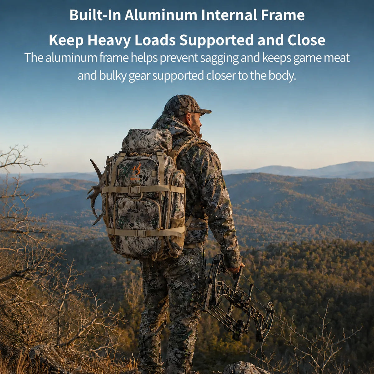 A hunter in full camouflage stands on a mountain overlook holding a bow, wearing a large backpack with the text overlay 'Built-In Aluminum Internal Frame Keep Heavy Loads Supported and Close' at the top.