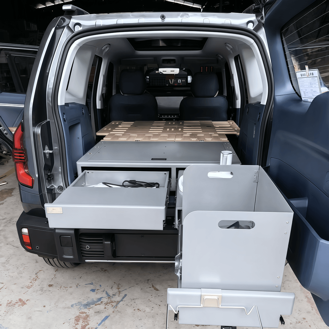 Tailgate kitchen slide of the SUV drawer system with stove and prep area