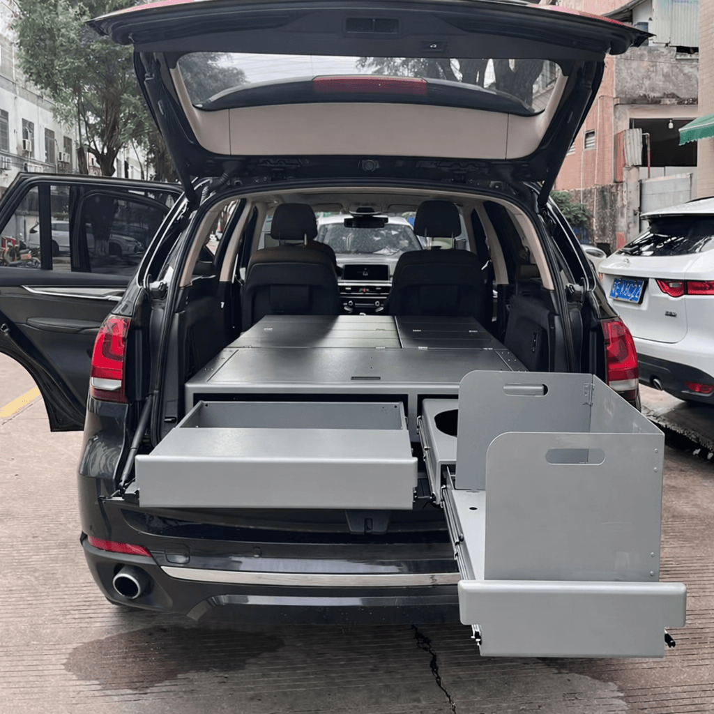Modular SUV sleeping platform and drawer system installed in SUV for overland camping