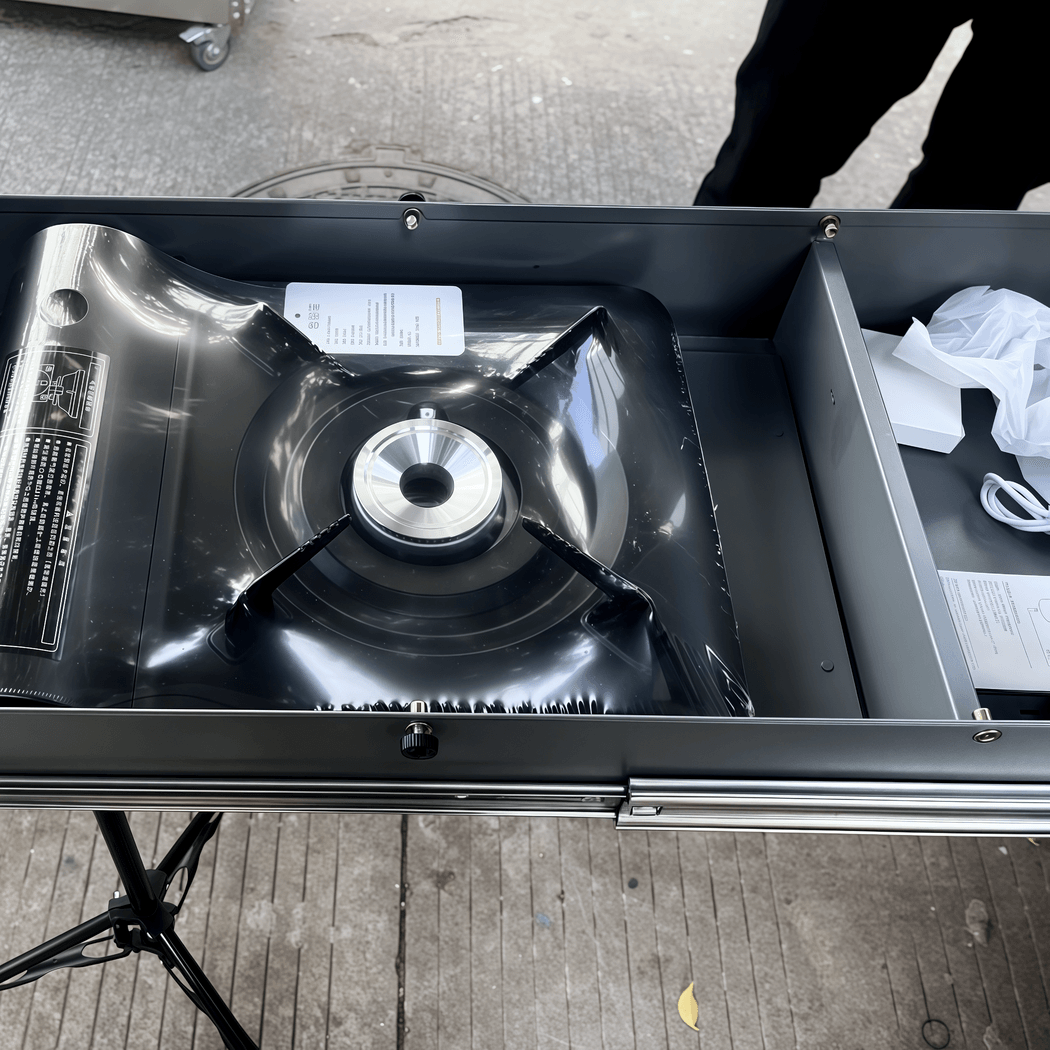 Integrated camp stove setup on modular SUV sleeping platform drawer slide